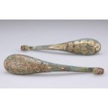A PAIR OF GOLD DECORATED BRONZE GARMENT HOOKS