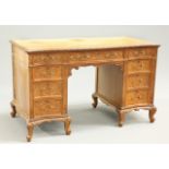 AN EARLY 20TH CENTURY CARVED WALNUT DESK