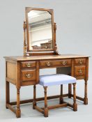 A PERIOD STYLE OAK DRESSING TABLE AND FOOTSTOOL BY TITCHMARSH AND GOODWIN