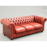 A DEEP BUTTONED RED LEATHER CHESTERFIELD SOFA