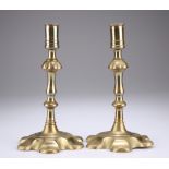 A PAIR OF 18TH CENTURY BRASS PETAL BASE CANDLESTIC