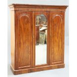 A MID VICTORIAN MAHOGANY THREE-DOOR WARDROBE