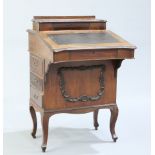 A LATE VICTORIAN WALNUT DAVENPORT