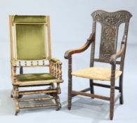 A LATE VICTORIAN CARVED OAK OPEN ARMCHAIR