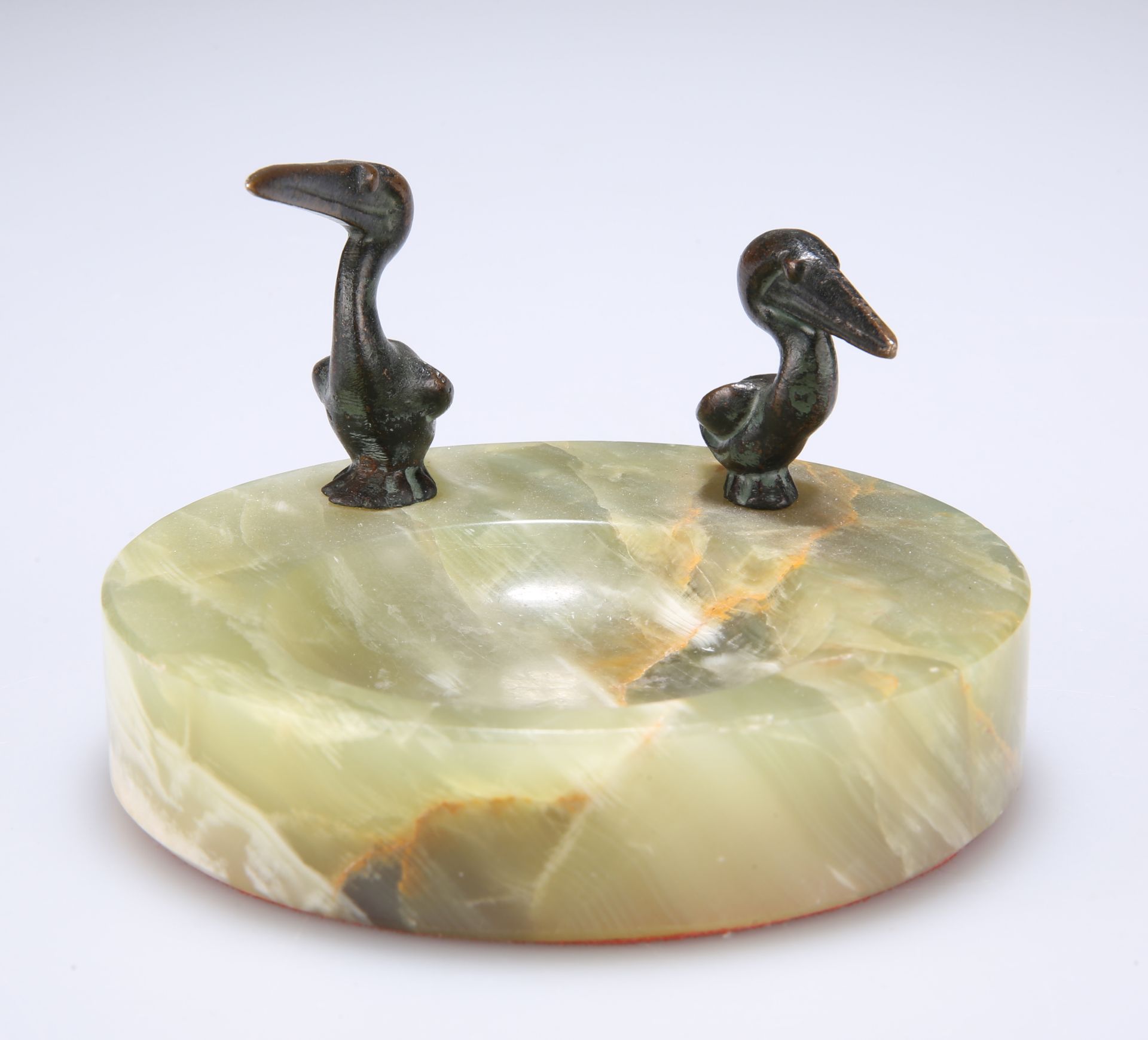 AN ONYX ASHTRAY MOUNTED WITH TWO BRONZE MODELS OF PELICANS