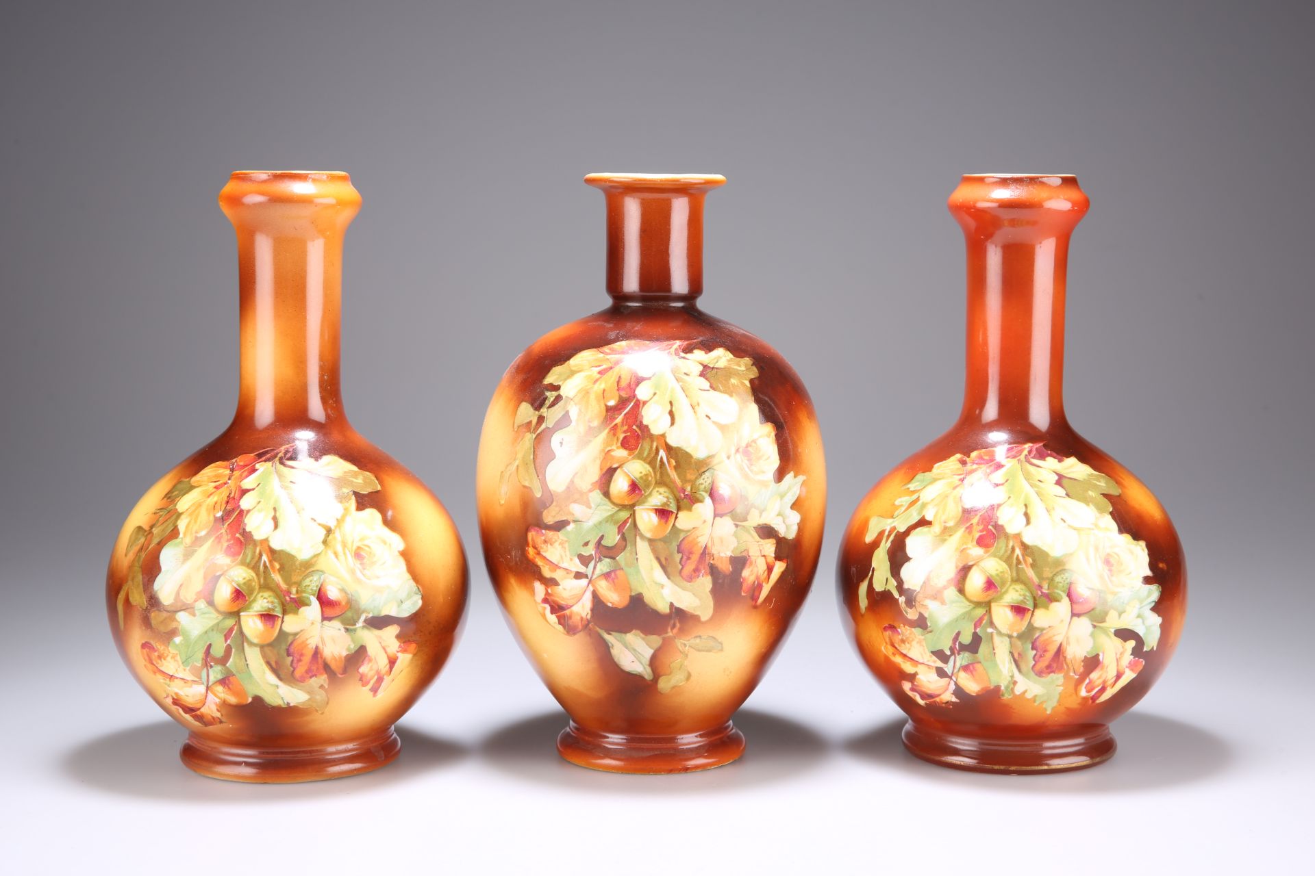 A GARNITURE OF THREE POTTERY VASES