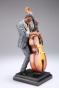 A COMPOSITION FIGURE OF A MALE MUSICIAN PLAYING A DOUBLE BASS