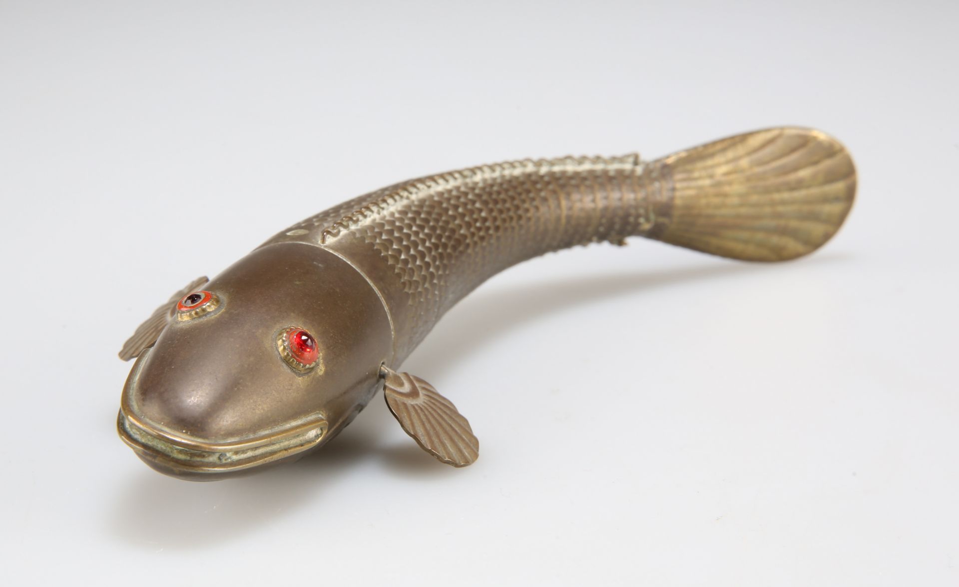 A BRASS ARTICULATED MODEL OF A FISH