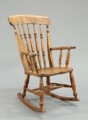A 19TH CENTURY ELM AND BEECH ROCKING CHAIR