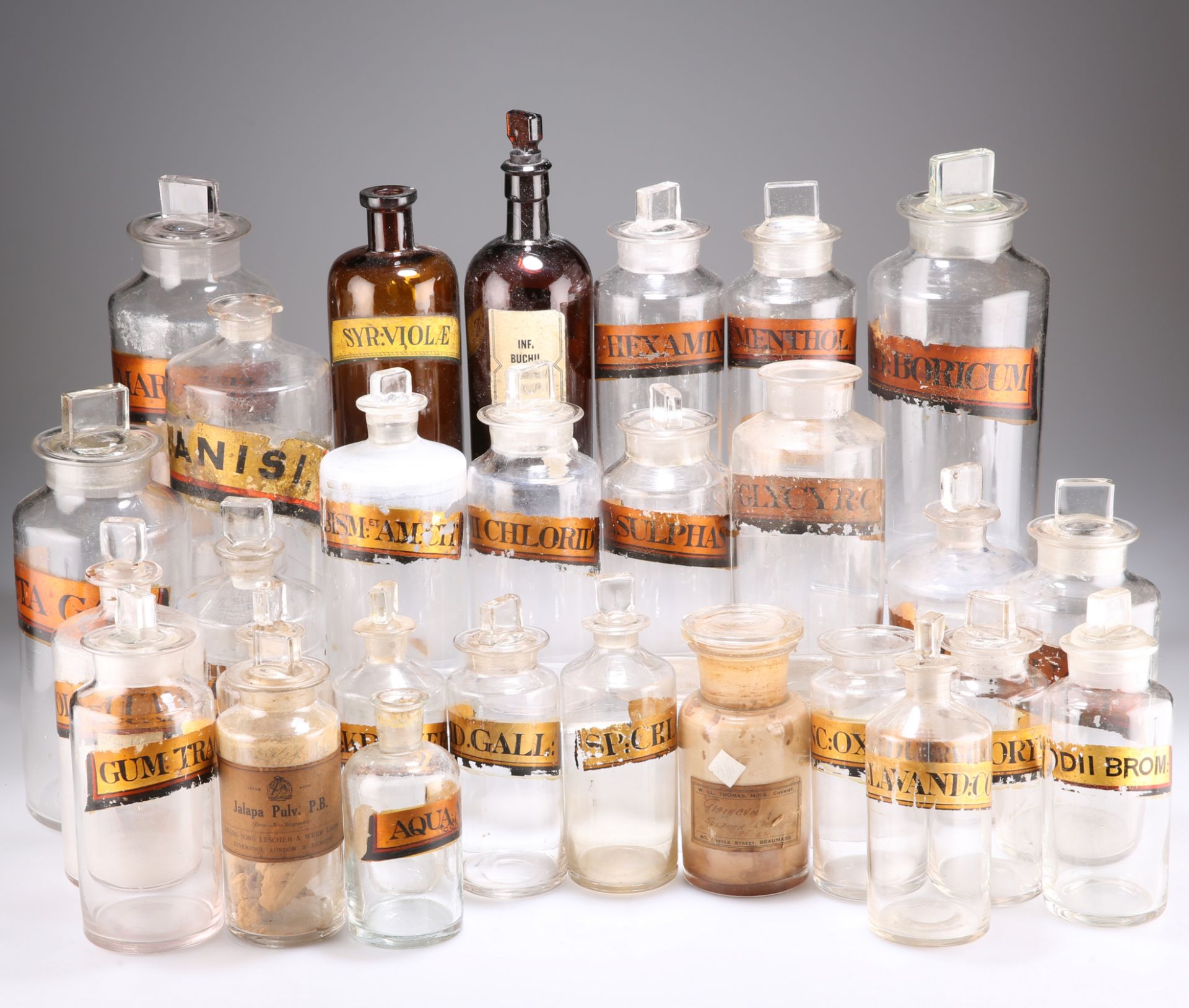 A QUANTITY OF VICTORIAN AND LATER GLASS APOTHECARY BOTTLES