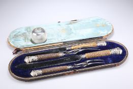 A CASED FOUR PIECE CARVING SET AND A SILVER MOUNTED GLASS MATCH STRIKE