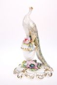 A ROYAL CROWN DERBY PORCELAIN MODEL OF A PEACOCK