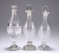 THREE ENGLISH GLASS CONDIMENT BOTTLES AND STOPPERS