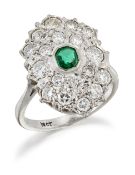 AN EMERALD AND DIAMOND CLUSTER RING