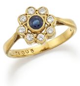 AN 18 CARAT GOLD SAPPHIRE AND DIAMOND CLUSTER RING