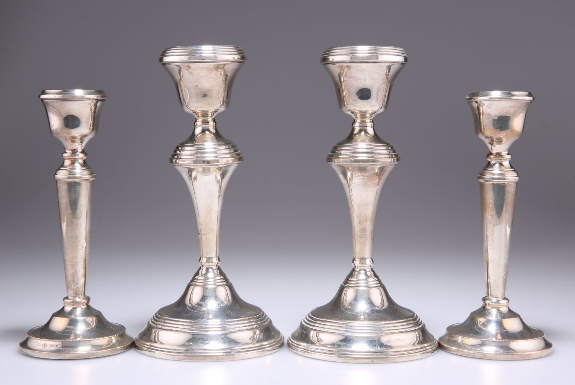 TWO PAIRS OF ELIZABETH II SILVER CANDLESTICKS