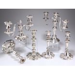 A GROUP OF SILVER-PLATED CANDLESTICKS AND CANDELABRA