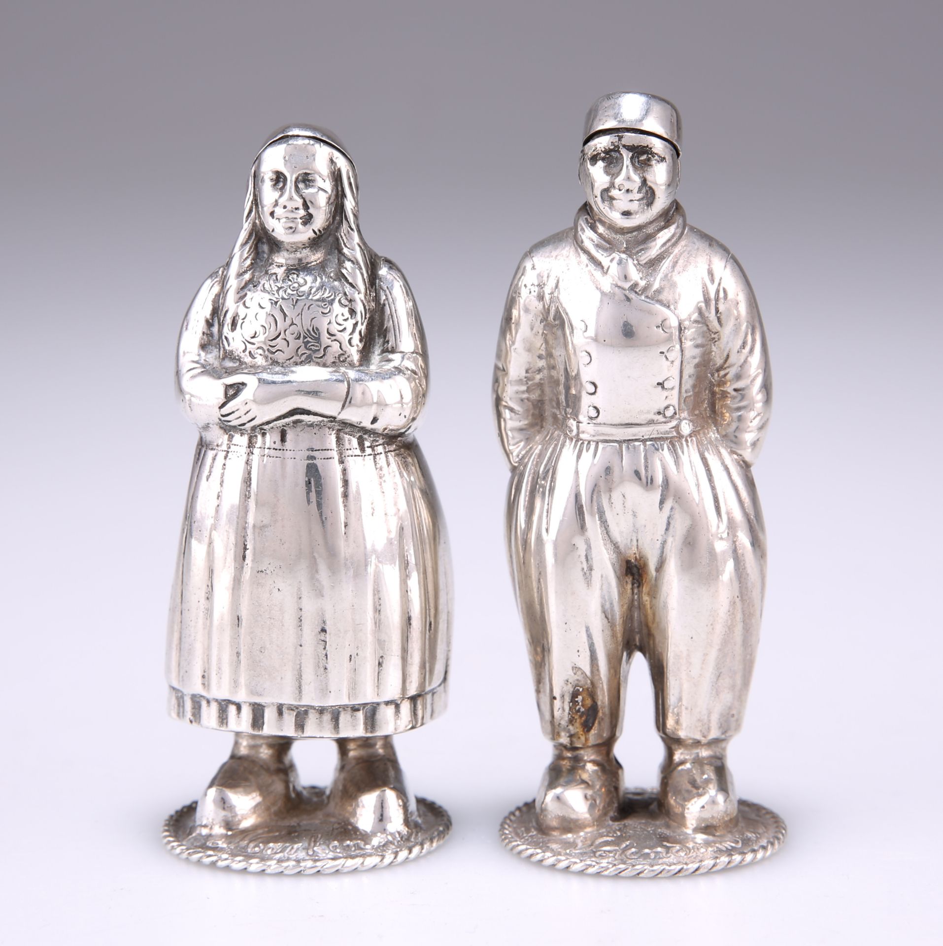 A PAIR OF DUTCH SILVER NOVELTY FIGURAL SALT AND PEPPER POTS