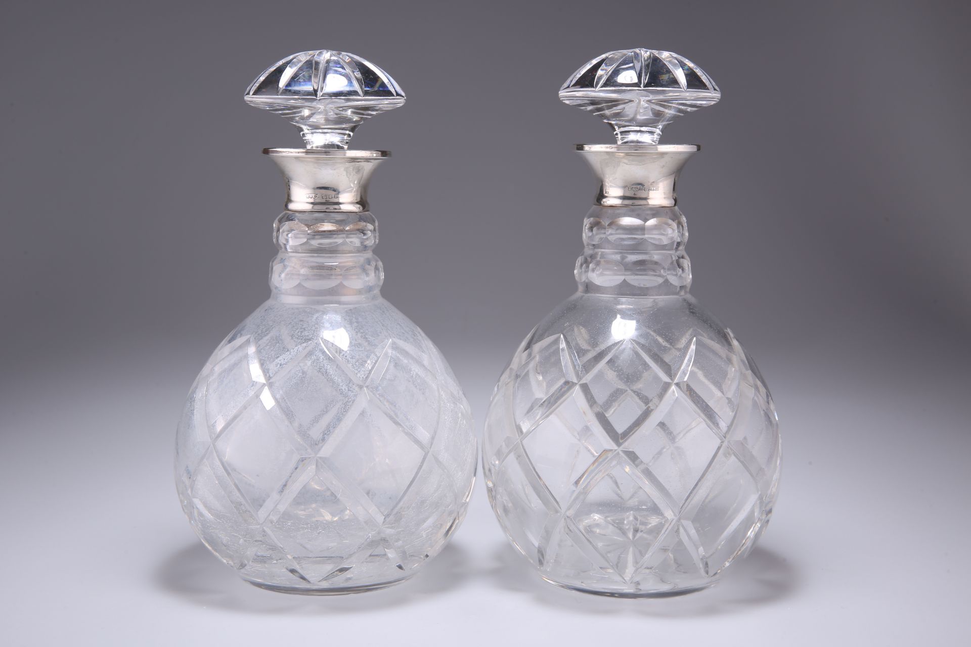 A PAIR OF ELIZABETH II SILVER-COLLARED DECANTERS