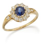 AN 18 CARAT GOLD SAPPHIRE AND DIAMOND CLUSTER RING