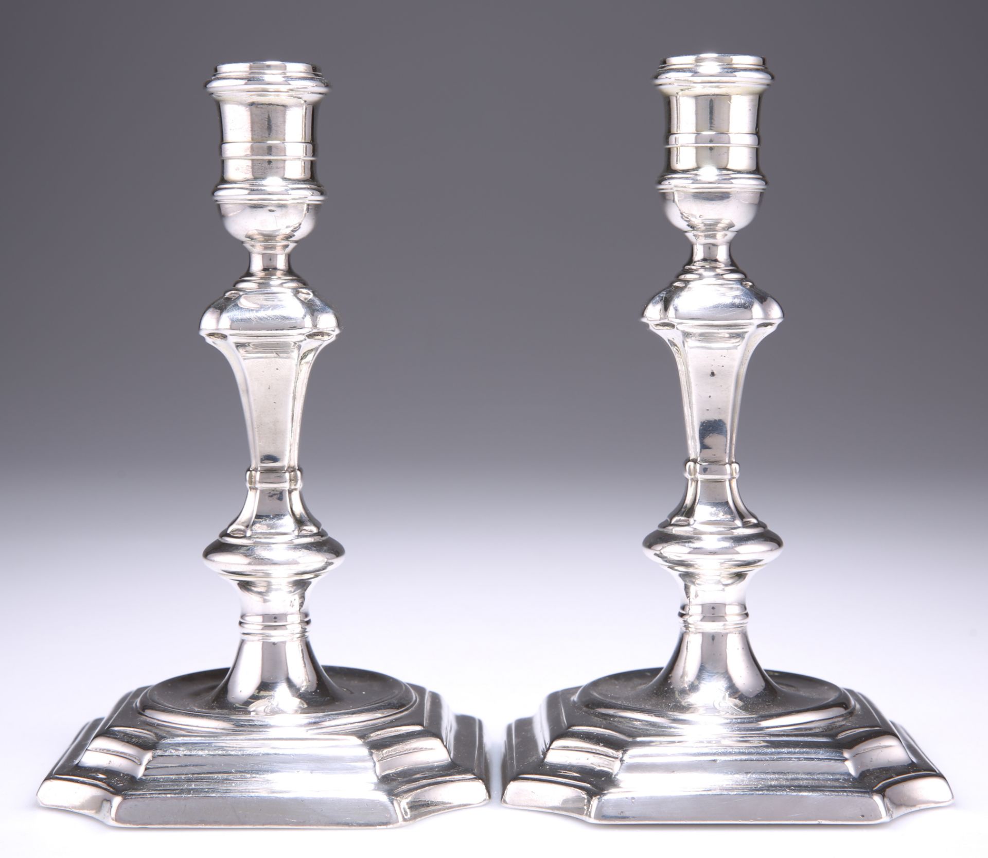 A PAIR OF GEORGE I SILVER CANDLESTICKS