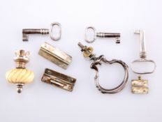 A COLLECTION OF CADDY KEYS, HINGES, ETC.