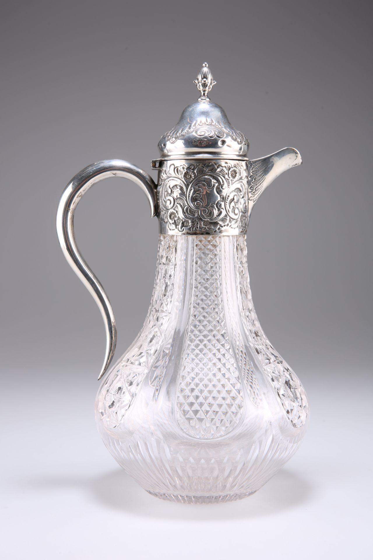 A LATE VICTORIAN SILVER-MOUNTED CUT-GLASS CLARET JUG