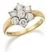 AN 18 CARAT GOLD DIAMOND CLUSTER RING