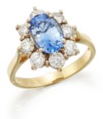 AN 18 CARAT GOLD SAPPHIRE AND DIAMOND CLUSTER RING