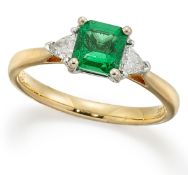 AN 18 CARAT GOLD EMERALD AND DIAMOND RING