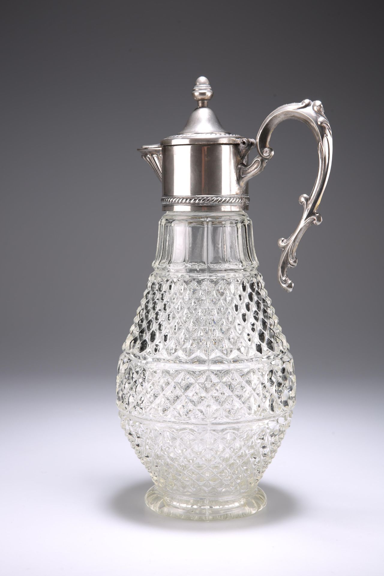 A SILVER-PLATE MOUNTED CLARET JUG