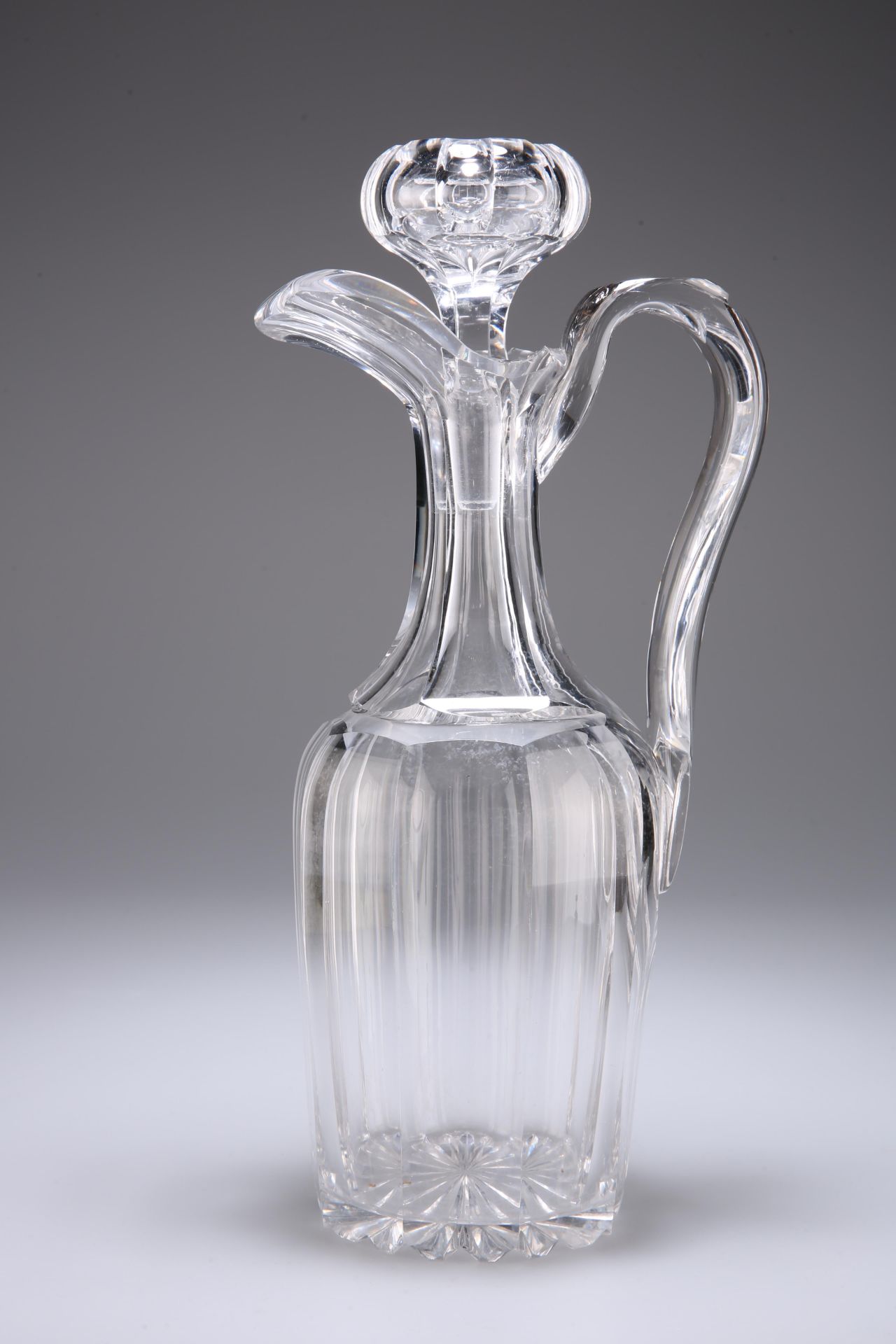 A HEAVY CUT-GLASS DECANTER, POSSIBLY BACCARAT