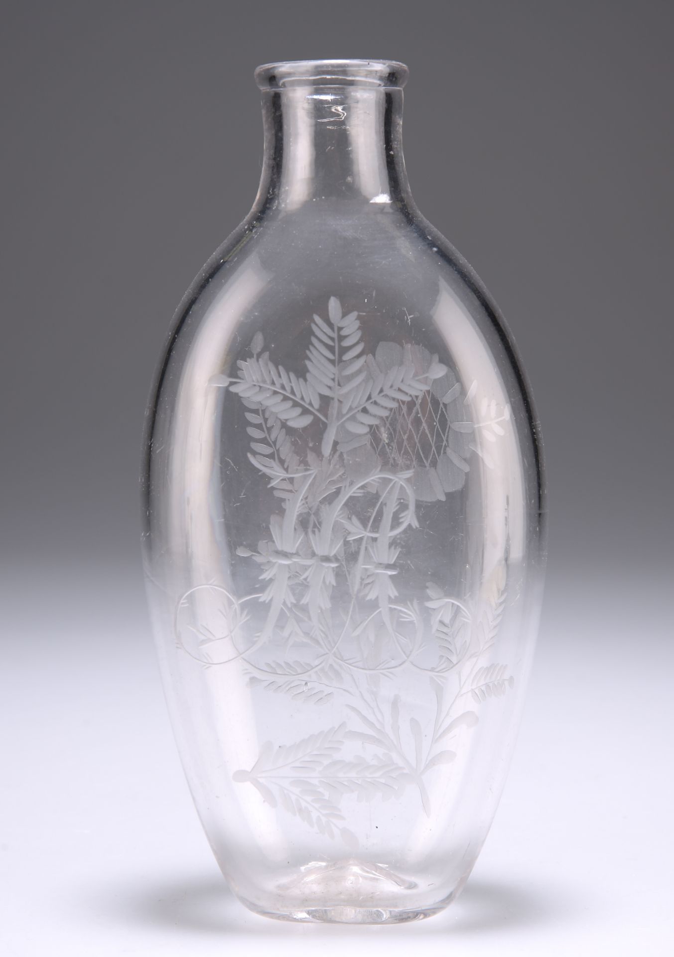 A 19TH CENTURY GLASS FLASK, ovoid, engraved with foliage to each side and to one side a monogram.