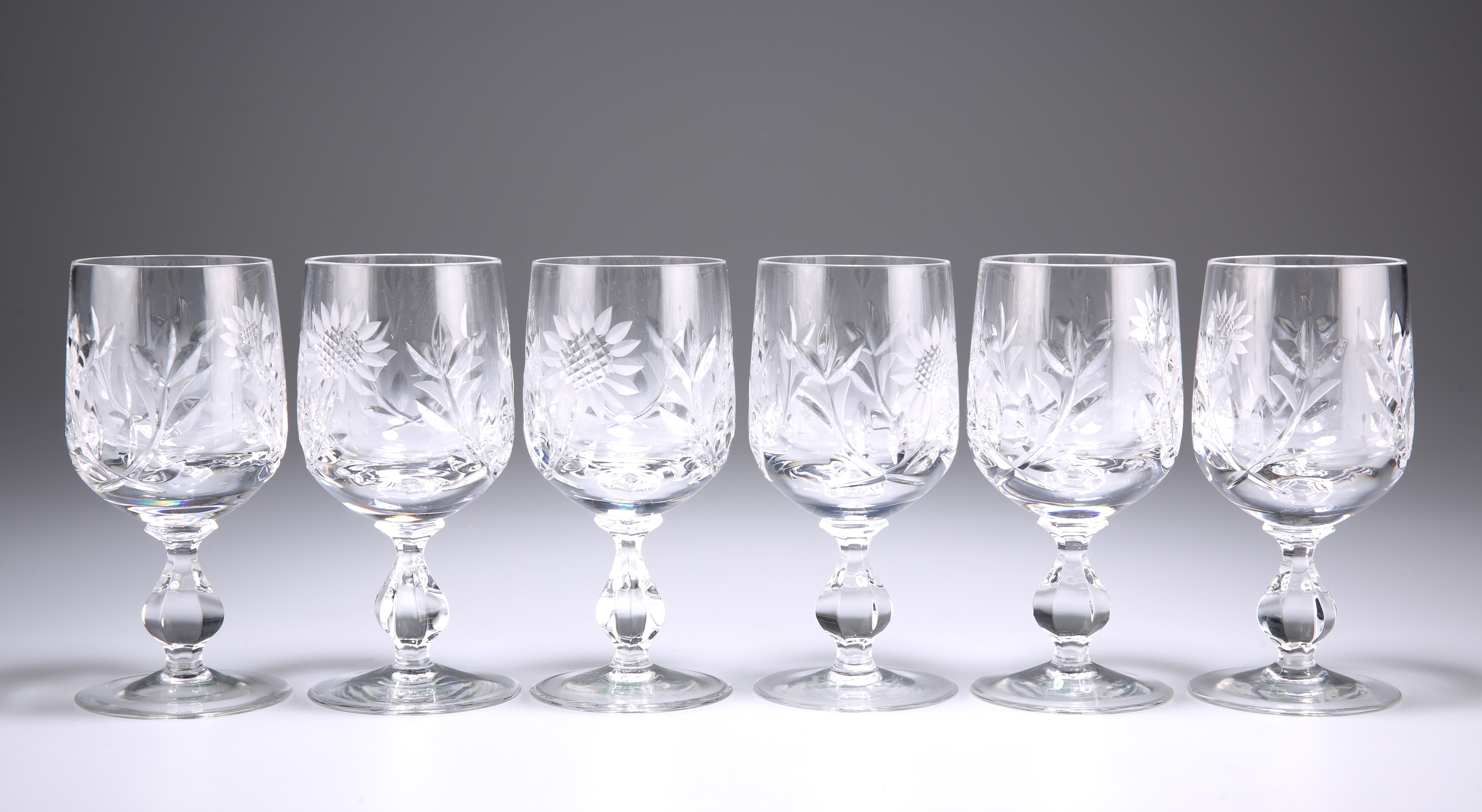 A SET OF SIX CUT-GLASS WINES