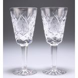 A PAIR OF WATERFORD SHERRY OR PORT GLASSES, with extensive cutting to the bodies, signed. 13cm