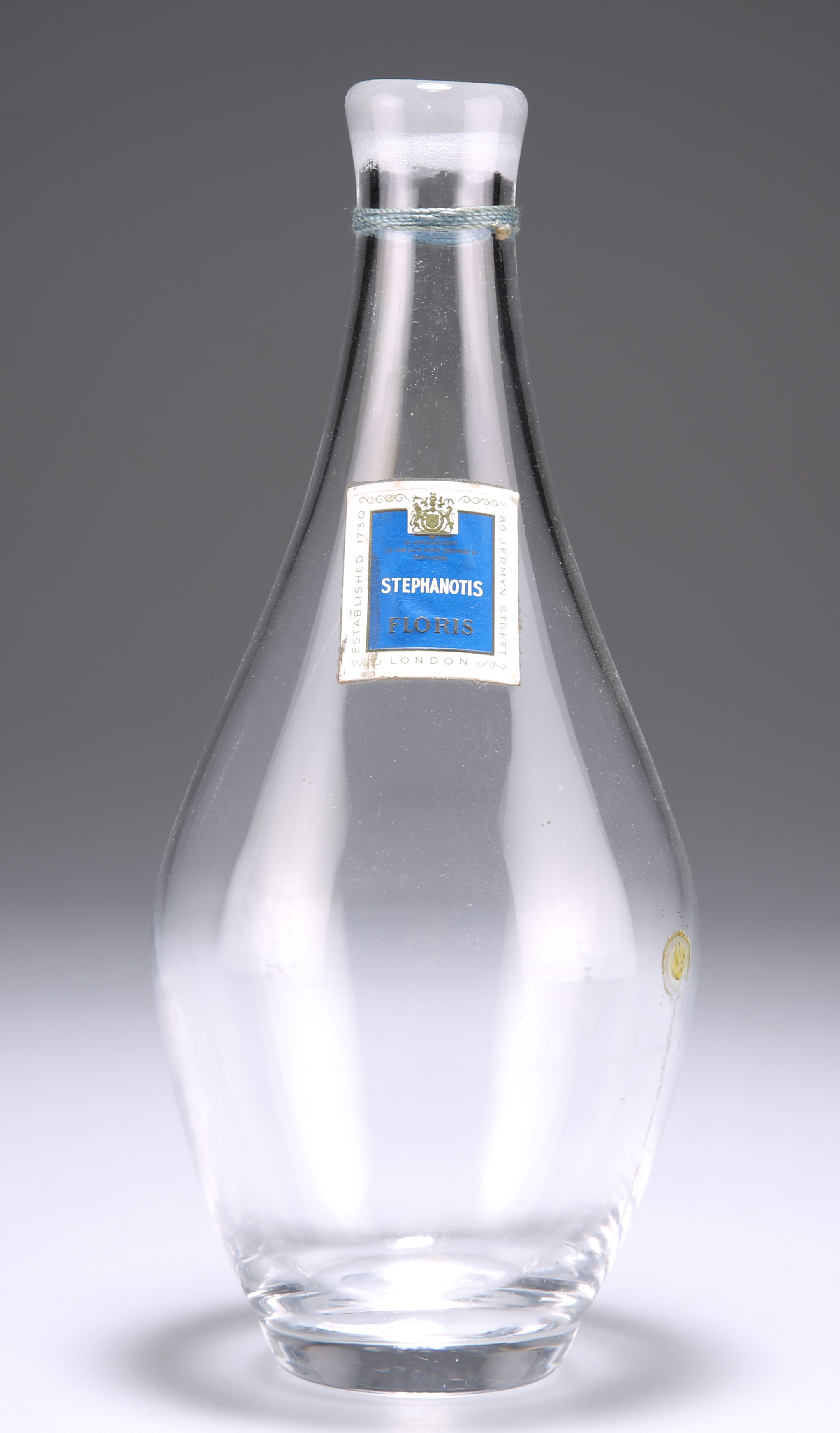 A PEAR-SHAPED GLASS PERFUME BOTTLE, with label for Stephanotis Floris, probably circa 1930. 22cm