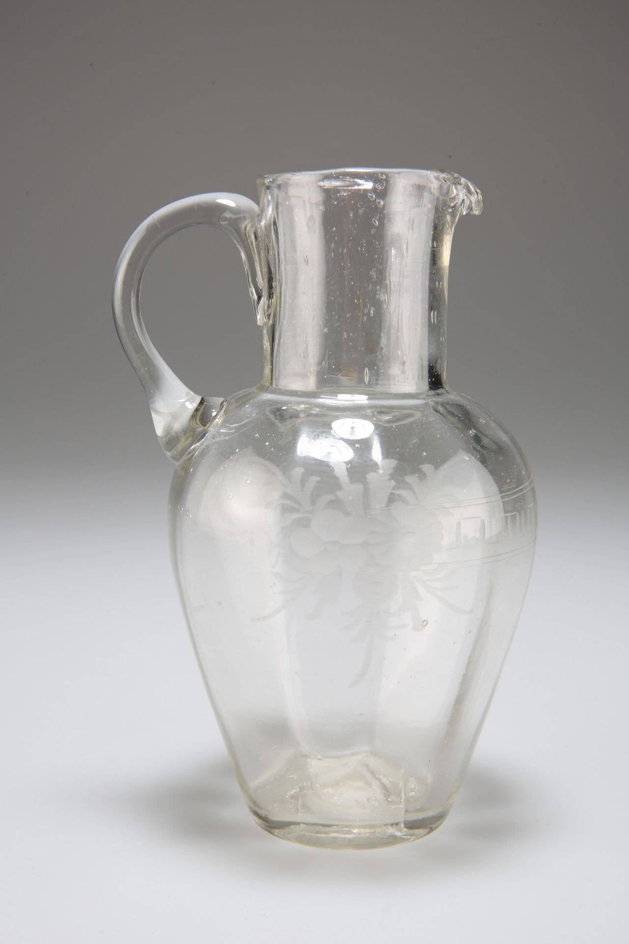 A RARE SHAPED ENGLISH GLASS SPIRIT JUG, CIRCA 1830