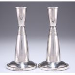 A PAIR OF MODERNIST SILVER CANDLESTICKS