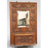GIGGLESWICK SCHOOL AN ARTS AND CRAFTS CARVED OAK HALL MIRROR CIRCA 1905
