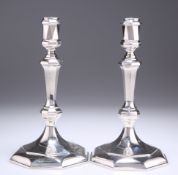 A PAIR OF MODERNIST CAST SILVER CANDLESTICKS