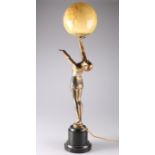 AN ART DECO PATINATED METAL FIGURAL TABLE LAMP
