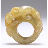 A CHINESE CARVED HARDSTONE RING OR TOGGLE