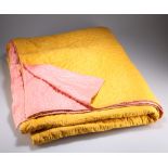 A VINTAGE MUSTARD AND PINK COTTON QUILT