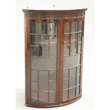 A VICTORIAN CHIPPENDALE STYLE MAHOGANY BOW-FRONTED HANGING CORNER CABINET