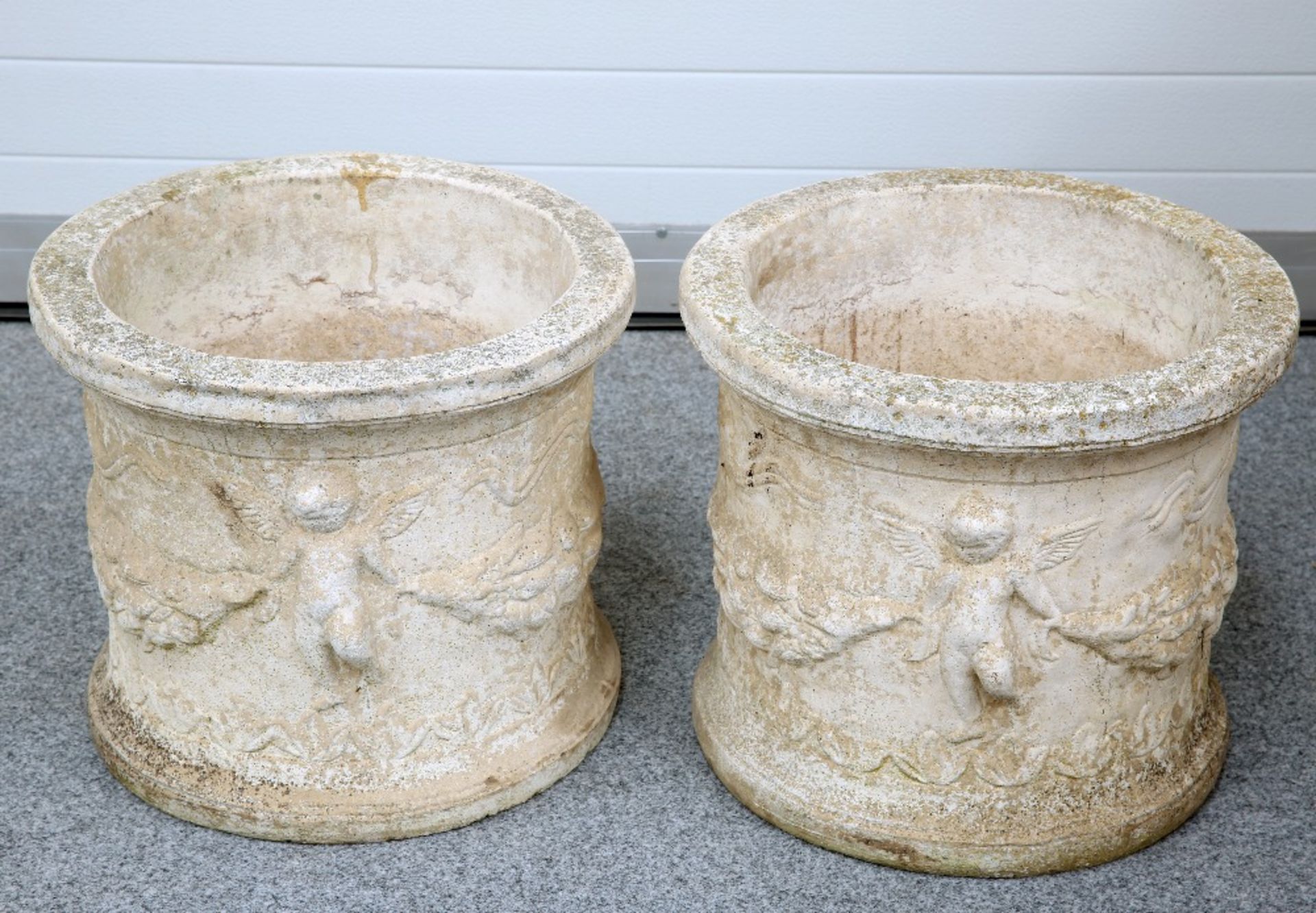 A PAIR OF COMPOSITE STONE PLANTERS