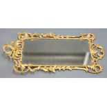 A LARGE ROCOCO STYLE GILT COMPOSITION MIRROR