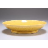 A CHINESE YELLOW-GLAZED PORCELAIN SAUCER DISH