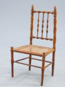 AN EDWARDIAN STAINED BEECH AND CANEWORK CHILD'S CHAIR