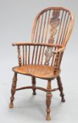 A 19TH CENTURY YEW WOOD AND ELM WINDSOR ARMCHAIR