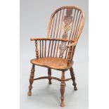 A 19TH CENTURY YEW WOOD AND ELM WINDSOR ARMCHAIR